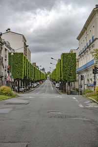 Road amidst buildings against sky