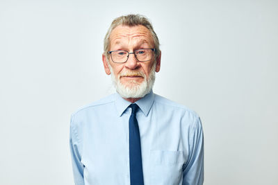 Portrait of senior man against white background