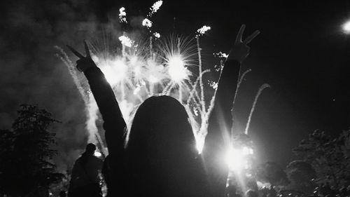 Low angle view of firework display at night