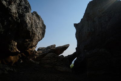 Low angle view of rock formation against sky