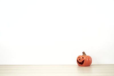 Close-up of toy on table against white background
