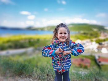 Portrait of happy girl standing outdoors