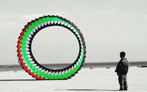 Man standing against multi colored sky