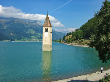 The bell tower of the former church of curon venosta in lake resia, south tyrol, italy.