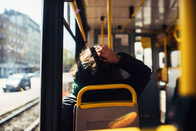 Rear view of man traveling in train