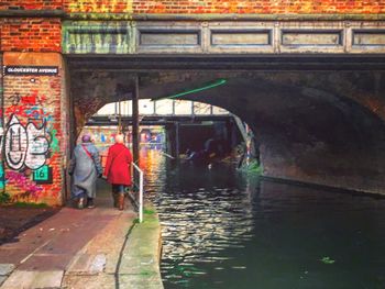 Rear view of people walking on wet floor