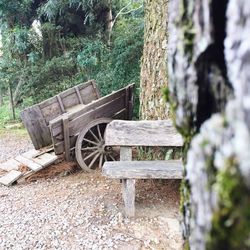 Chair on field against trees