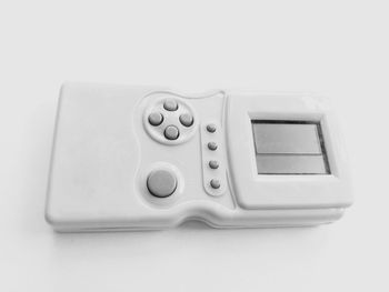 High angle view of telephone on table against white background