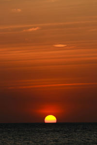 Scenic view of sea against romantic sky at sunset