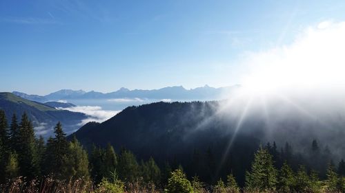 Scenic view of mountains against bright sun