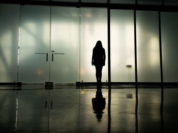 Silhouette woman walking with shadow on floor