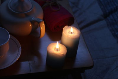 Close-up of lit candles on table