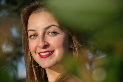 Close-up portrait of smiling young woman