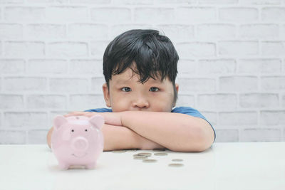 Portrait of boy against black wall