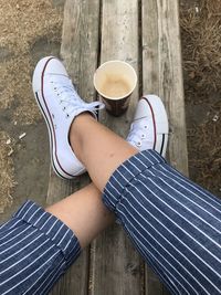 Low section of woman with coffee cup