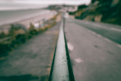 Close-up of railing against road