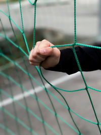 Close-up of hand holding rope