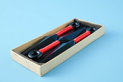 Close-up of colored pencils on table against blue background