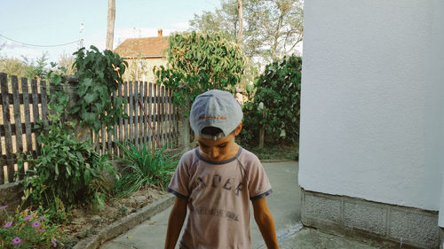 Rear view of man standing against plants