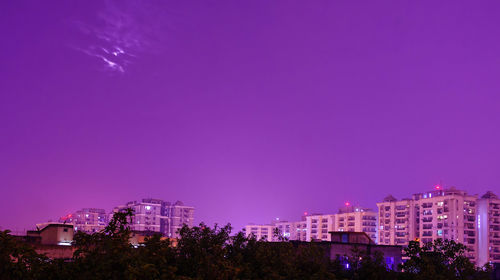 Low angle view of illuminated buildings at night