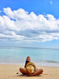 Man on beach by sea against sky