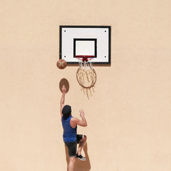 Low angle view of man playing basketball