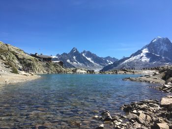 Scenic view of snowcapped mountains against clear blue sky