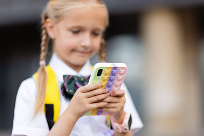 Portrait of girl photographing with mobile phone