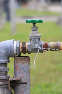 Close-up of faucet on field