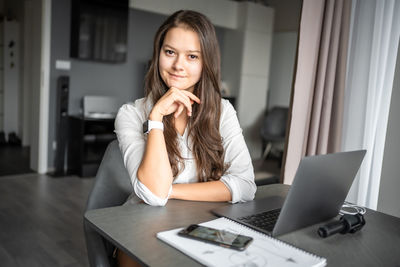 Young woman using laptop at home