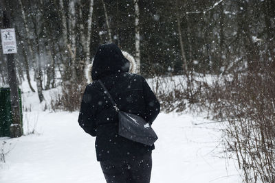 Rear view of woman on snow covered land