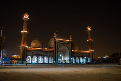 Illuminated buildings against sky at night