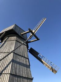 Low angle view of traditional windmill against clear sky