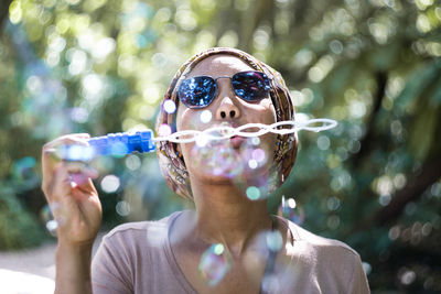 Close-up of young woman using mobile phone