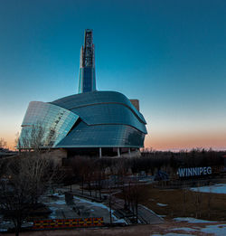 Built structure on field against clear sky at dusk