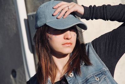 Portrait of beautiful young woman wearing hat