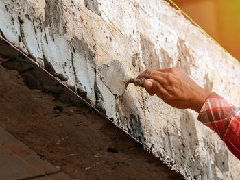 Close-up of hand on wall