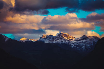 View of snowcapped mountain against cloudy sky