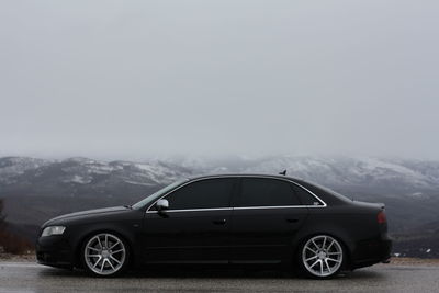 Vintage car on mountain against sky