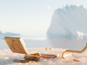 Restorative escape concept. winter arctic surreal place with fluffy carpet and wooden lounge