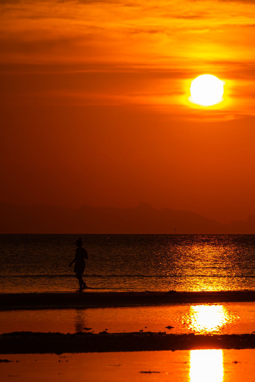 SILHOUETTE PEOPLE STANDING AT BEACH DURING SUNSET