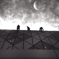 Low angle view of building against cloudy sky