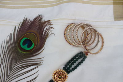 High angle view of feather on white table