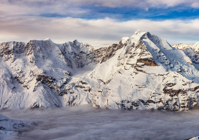 Scenic view of snowcapped mountains against sky