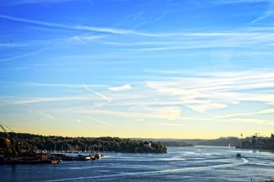 Boats in sea against blue sky