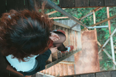 High angle view of woman sitting on steps