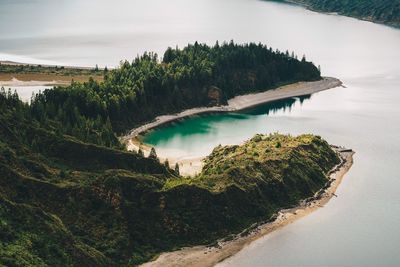 High angle view of river amidst trees against sky