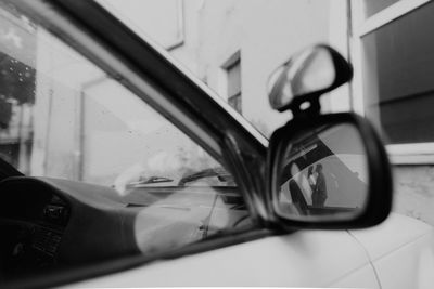 Close-up of car window on side-view mirror