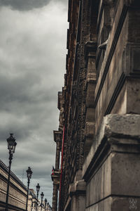 Low angle view of building against cloudy sky
