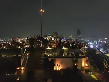 High angle view of illuminated buildings against sky at night